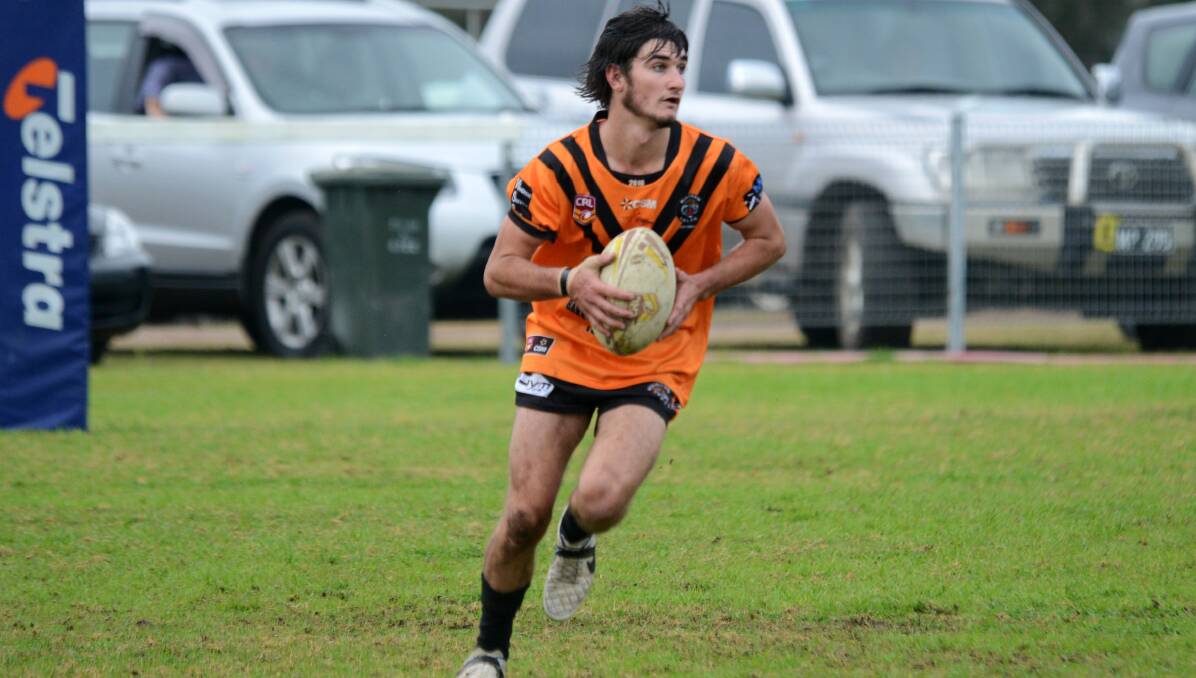 In-form Wingham fullback Blake Sky on the run in the clash against Old Bar at the Wingham Sporting Complex.