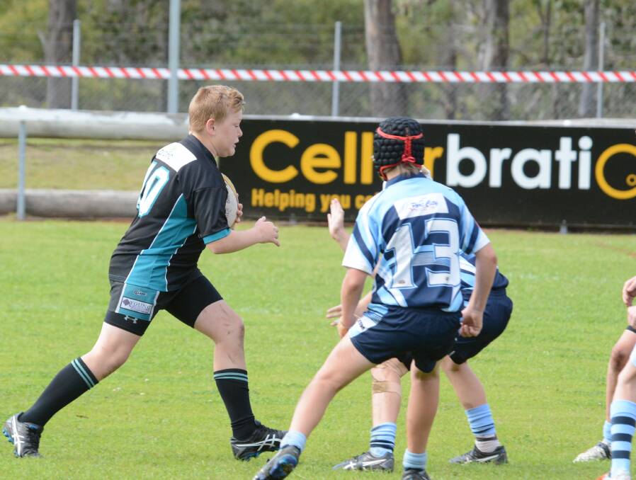 Taree's Oscar Holt about to take on the Port City defence during the Group Three under 12 final played at Wingham. Port won the game.