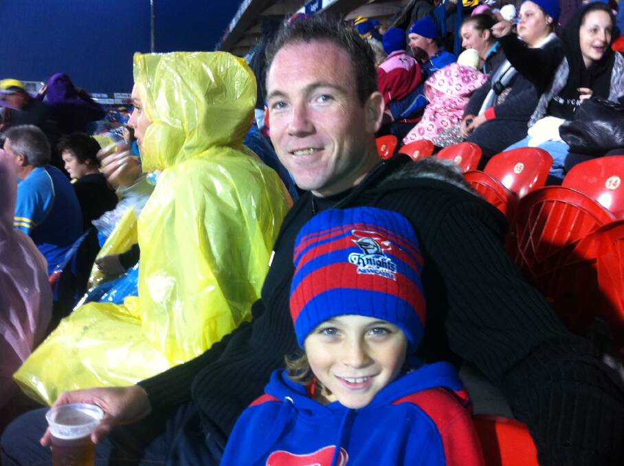 A day out with Dad: Derek Kerry and his son Riley enjoy a game at MacDonald Jones Stadium watching a Newcastle Knights game not long before his death. Picture. Supplied