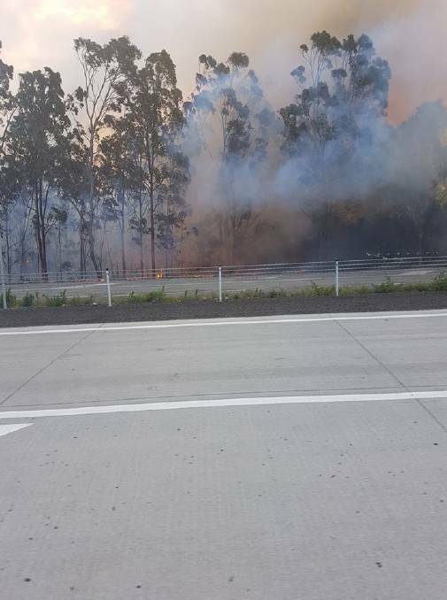 A fire burning alongside the Pacific Highway near Kempsey. 