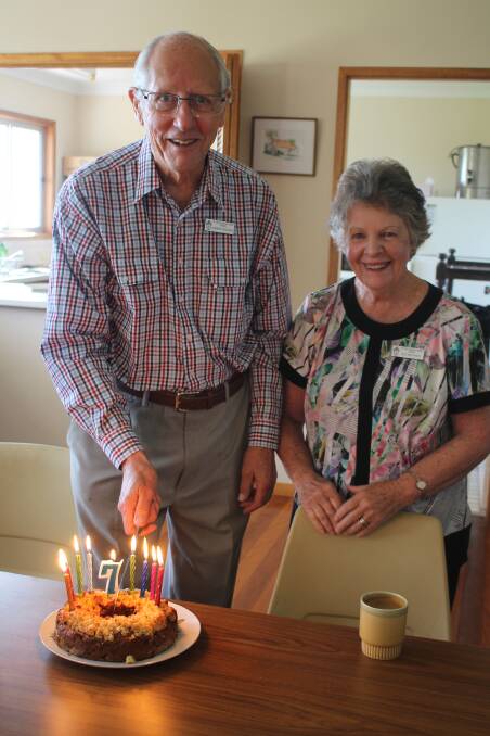 Andrew Prentice cutting his birthday cake with wife Sue during morning tea at St. Luke’s Tinonee.