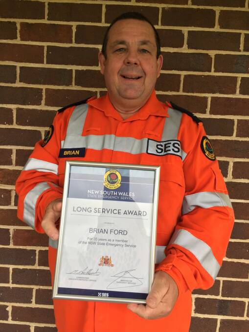 Honoured: The Reverend Brian Ford with his long service award for 35 years of service with the NSW State Emergency Service (NSW SES). Photo: Sam Brownrigg