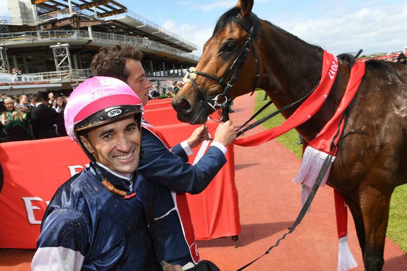 Homegrown talent: Jockey Corey Brown returns to scale with Rekindling after winning the 2017 Melbourne Cup. Brown hails from Wingham. Photo: AAP Image/Julian Smith.