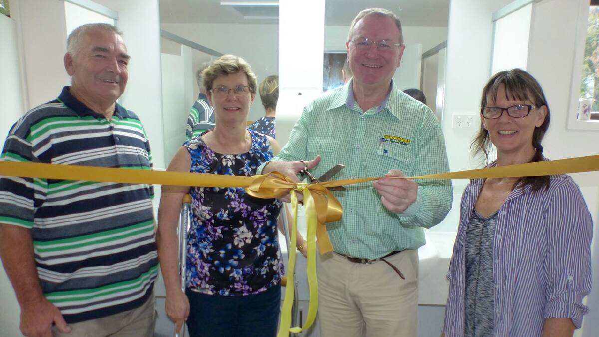 It's official: Don Gibson, Michelle Swannack and Trudy Alm (right) of the Killabakh Community Association watch on as member for Myall Lakes Stephen Bromhead cuts the ribbon to open new toilets at the hall.
