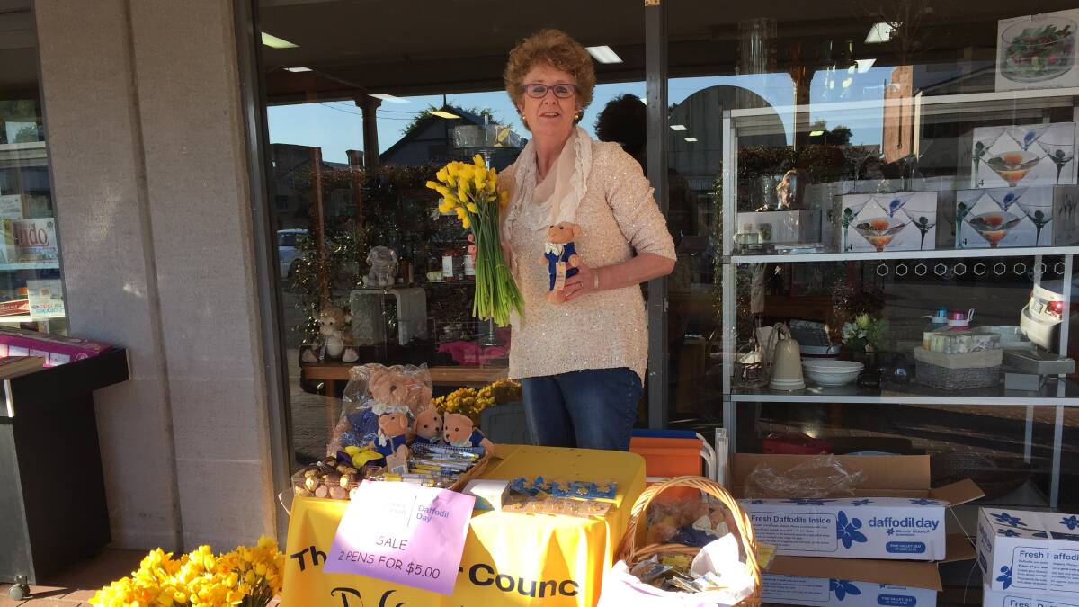 Frances Barberie selling daffodils and other merchandise for Daffodil Day in Wingham.