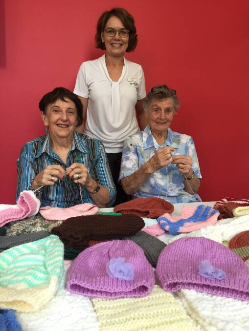 Wingham Library Knitting Group members Lyn McKinlay and Audrey Richardson with Wingham Librarian Sheryl Amos.