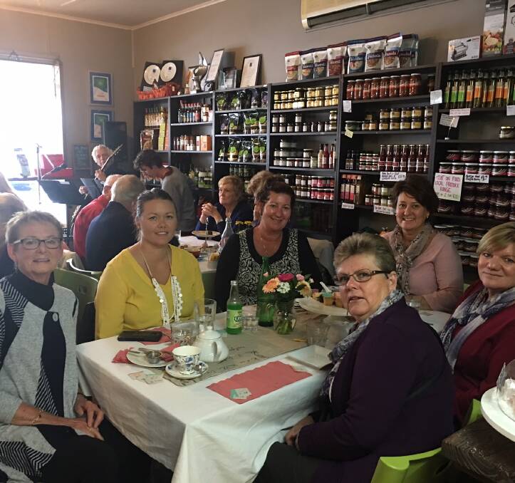 More than 60 people filled Wingham's Bent on Food to listen to Keith Bedggood and Craig Bourke play and enjoy a fundraising high tea for the Cancer Council.