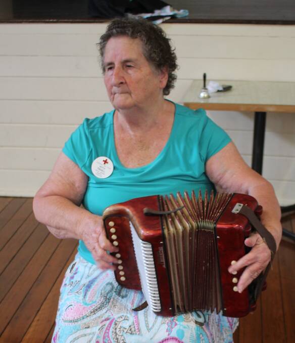Traditional sound: Mt George Red Cross member Kitty Tisdell entertains guests at the St Patrick’s Day Luncheon.