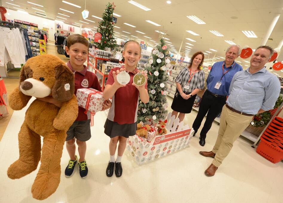 Target Taree is supporting the UnitingCare Christmas appeal and co-ordinator Pastor David Freeman (second from right) is urging people to buy a gift tag or leave a gift under the tree. Kerry Hawa and Connor, Tyla and Glenn Humphrey hope the community act and give generously.