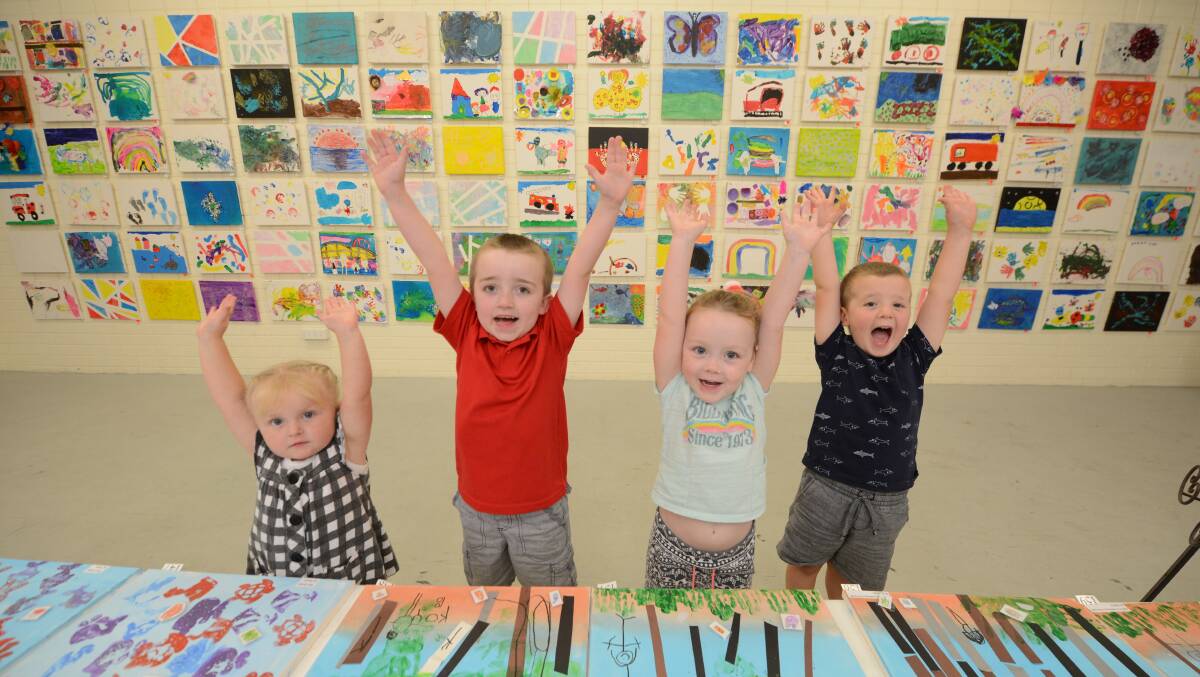 Young artists Gemma Oberg, Phoenix Wilson, Charli Donaldson and Mitchell Scope jump for joy in Manning Regional Art Gallery as they see their art on the walls.