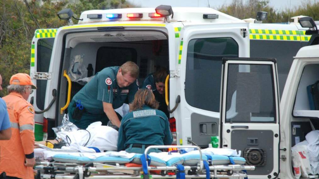Harrowing final moments: Esperance St John Ambulance community paramedic Paul Gaughan with emergency services desperately trying to save 17-year-old Laeticia Brouwer's life, at the Wylie Bay Beach car park, as her family watch on. Photo: Caitlyn Rintoul.
