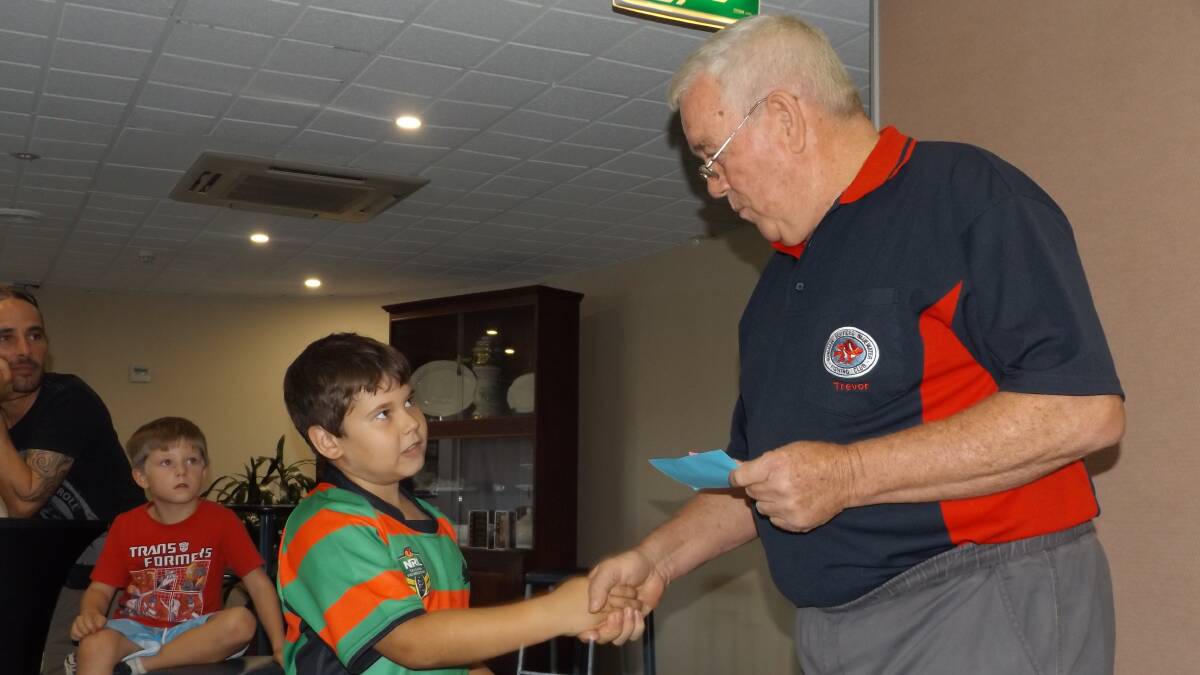Well done: Wingham Services Bluewater Fishing Club junior winner of the Beach, Rock and Estuary Tyrene Reeve receives his prize from Trevor Green. Photo: supplied.