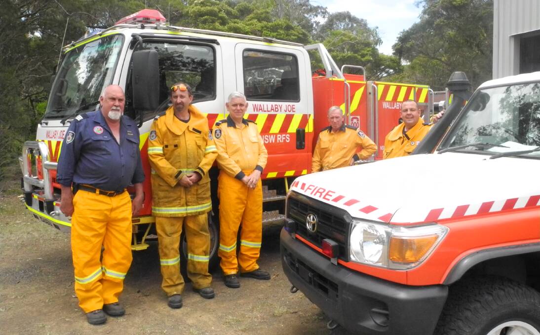 Shiny new toys: Bob Pope, Kristian Guppy, Barry Sandwell, Colin Davie and Brian Ford of the Wallaby Joe Rural Fire Brigade and their two new vehicles. 