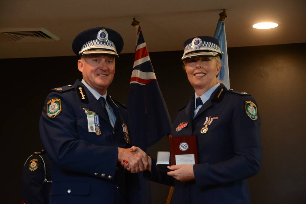 Acting Asst Commissioner Peter Thurtell presents Chief Inspector Christine George with her National Police Service Medal in 2016.