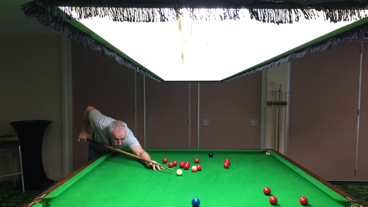 Having a go: Alan Franklin at one of the two newly relocated snooker tables at Wingham Memorial Services Club.
