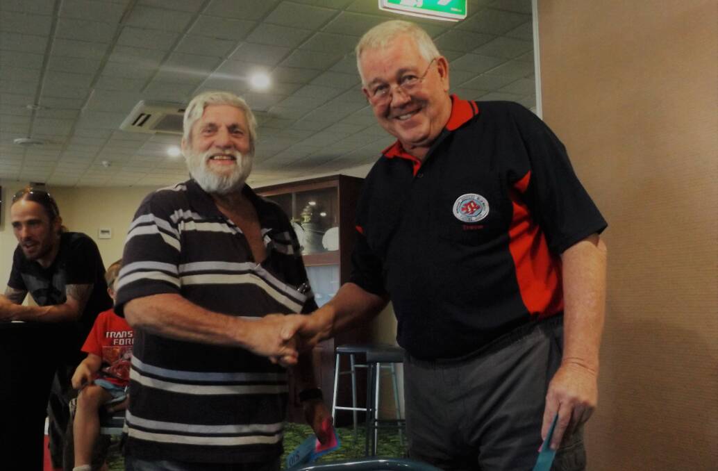 Great catch: Wingham Services Bluewater Fishing Club winner of Beach, Rock and Estuary Garry Green, is presented with his prize by Trevor Green. Photo: supplied.