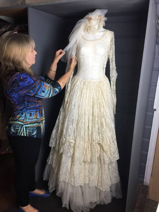 Kim Armstrong displaying Betty Wadsworth's (nee Gross) 1957 wedding gown. 
