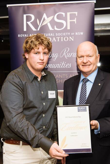 Lachlan James receiving his award from Royal Agricultural Society president Robert Ryan.
