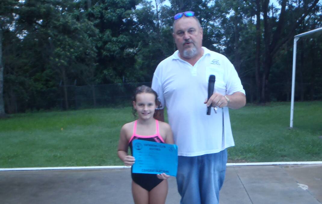On the way up: Eva Greenaway at Wingham Swimming Pool with a certificate confirming a record-breaking swim. Photo: supplied