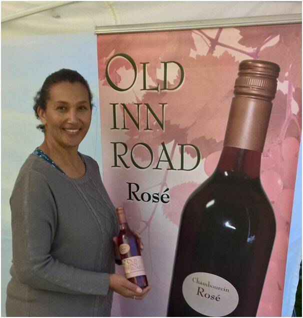 Sooze Bosire of Old Inn Road with a bottle of their new season Chambourcin Ros .