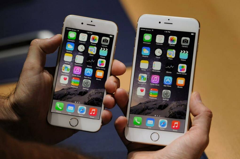 new Apple Inc. iPhone 6, left, and iPhone 6 Plus for a photograph after a product announcement at Flint Center in Cupertino, California, U.S., on Tuesday, Sept. 9, 2014. Apple Inc. unveiled redesigned iPhones with bigger screens, overhauling its top-selling product in an event that gives the clearest sign yet of the company's product direction under Chief Executive Officer Tim Cook.  Photo: Photographer: David Paul Morris/Bloomberg
