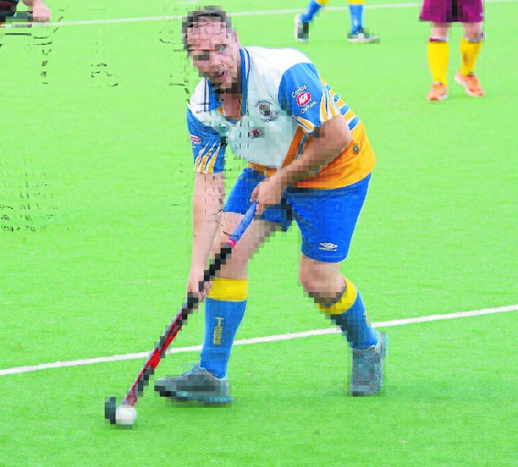 Phil Baker from Tigers playing in last season's Manning A-grade hockey grand final against Chatham. Port Macquarie teams could be added to the competition in 2016.