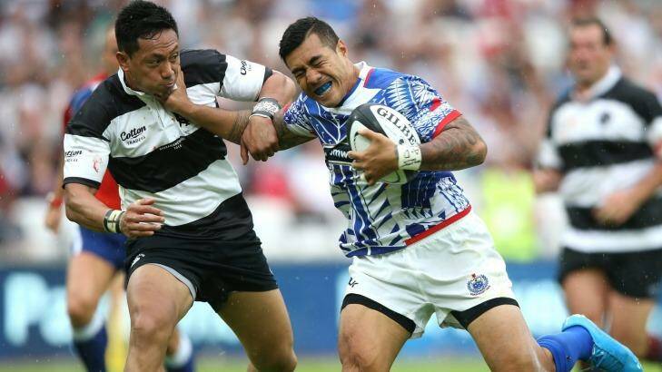 Christian Lealiifano (left) attempts to tackle Samoa's Tusi Pisi while playing for the Barbarians in London last weekend.
 Photo: David Rogers