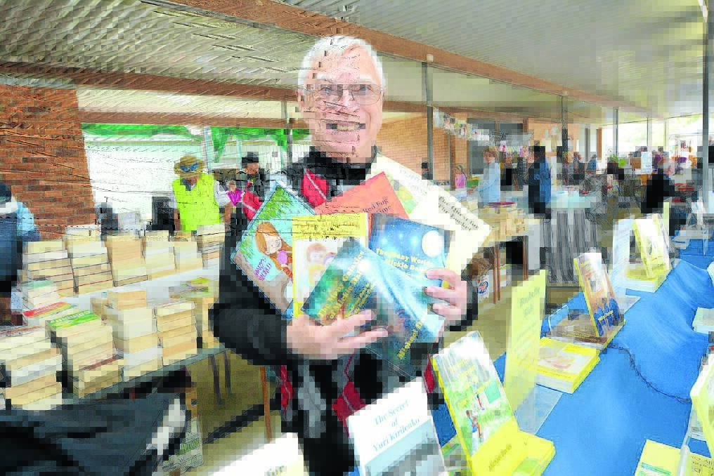 Michael Davies with a collection of books he has worked on with school children.