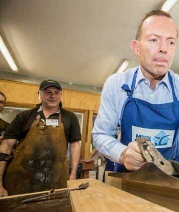 Tony Abbott gets dirty at the Mosman Men's Shed: a Father's Day boost. Photo: Cole Bennetts