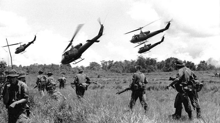 As the jungle war against the Vietcong intensifies in Vietnam, Australian soldiers of the 1st Battalion scatter for cover after landing from helicopters to start a search and destroy operation in War Zone "D" in early July, 1965. Photo: Stuart MacGladrie
