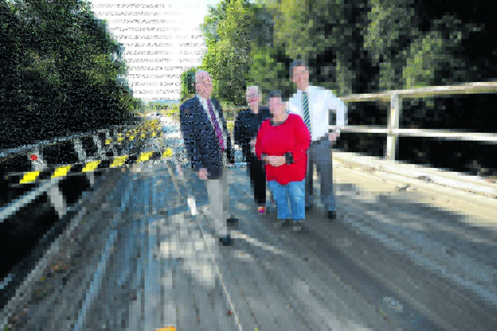 Deputy Prime Minister Warren Truss, acting mayor Robyn Jenkins, Dyers Crossing resident and general store operator Erica Gordon and member for Lyne David Gillespie at Dyers Crossing bridge on Wednesday.