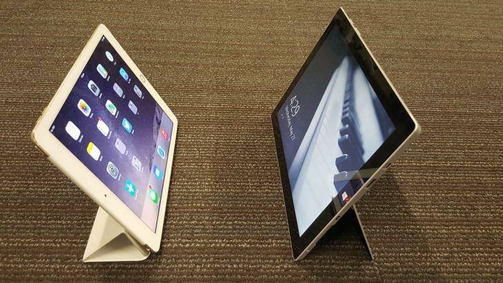 The Surface 3's built-in stand (right) is sturdier than the iPad's signature fold-up stand. Photo: Hannah Francis