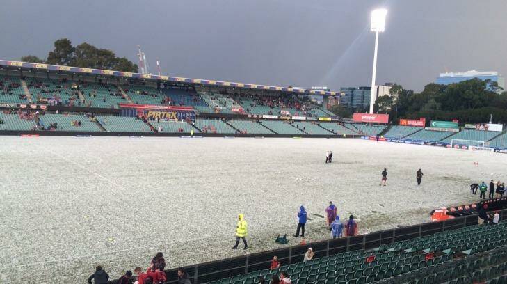 Parramatta Stadium is blanketed in hailstones.