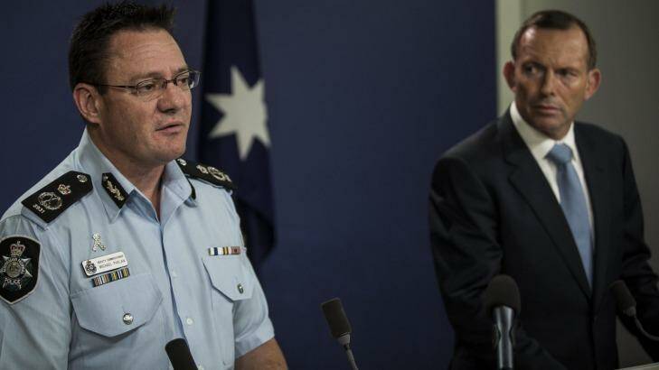 AFP Deputy Commissioner Michael Phelan and Prime minister Tony Abbott speak in Sydney on Saturday. Photo: Dominic Lorrimer
