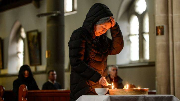Helen Donnellan lights a candle at the vigil for Andrew Chan and Myuran Sukumaran who face execution in Indonesia for drug smuggling. Photo: Justin McManus