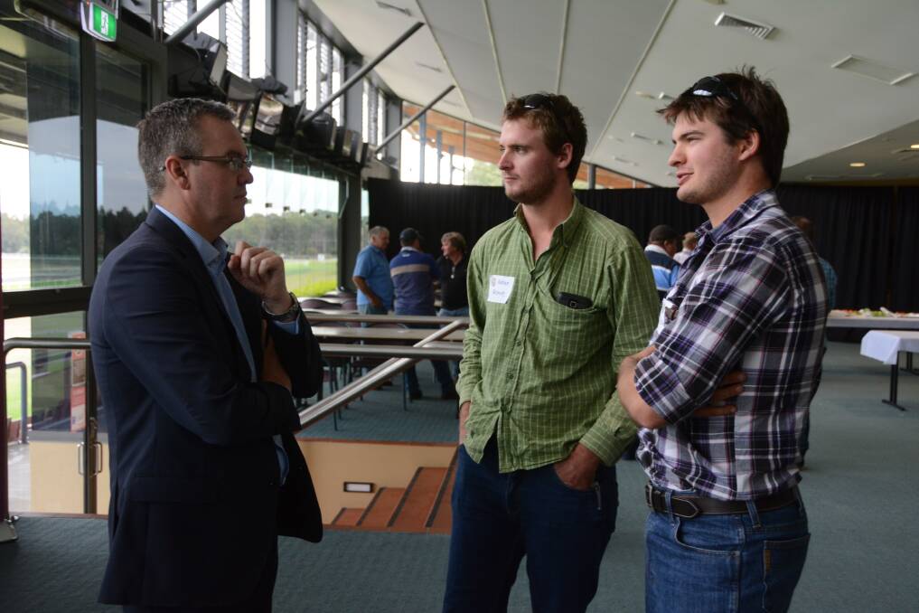 Executive general manager supplier relations Robert Poole talks to Wingham farmers Adrian and Aaron Brown at the Murray Goulburn suppliers meeting at Taree racecourse. 