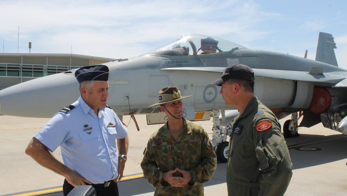 Senior ADF officers at the RAAF Amberley Air base with one of the FA-18 classic Hornets that will patrol the skies over Brisbane during the G20 Leaders Summit this weekend. (from left) Senior Australian Defence Force Officer RAAF Base Amberley, Air Commodore Tim Innes, Commander ADF Support to the G20, Major General Stuart Smith and Wing Commander David Smith  - photo Brian Hurst 