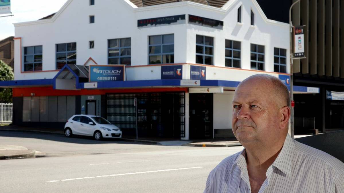 Andrew Walker of Street Real Estate, standing outside the old Street Real Estate office that was all but destroyed in the Newcastle Earthquake.
