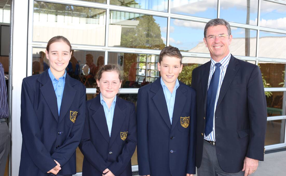 Students of St Joseph's Primary School Wingham Chelsea Allan, Erin Horsington and Callum Owen with Anzac Day liturgy guest Federal member for Lyne Dr David Gillespie
