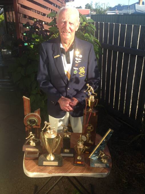 Ron proudly displaying his many bowling trophies.