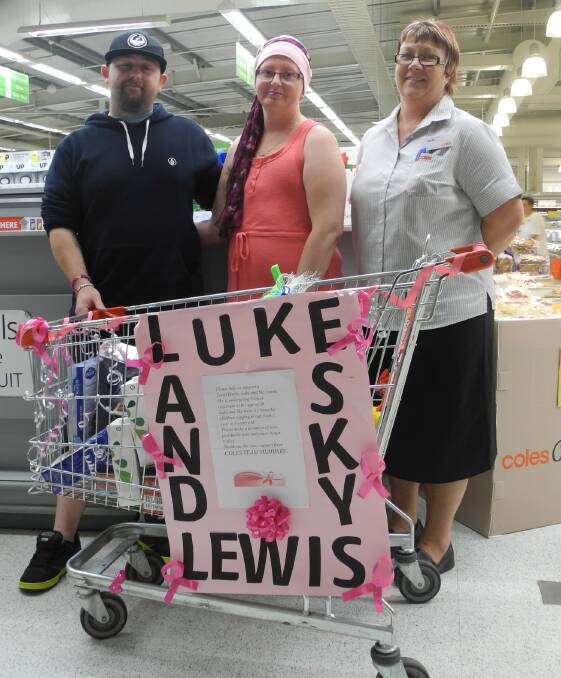 Luke and Sky Lewis with Jackie Latimore and the donation trolley at Coles in Wingham