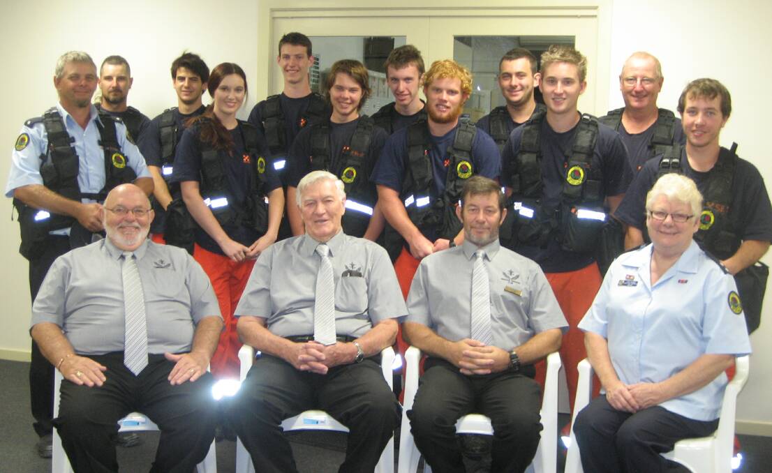 Wingham SES volunteers try on their new utility vests at a supper for the directors of Wingham Memorial Services Club