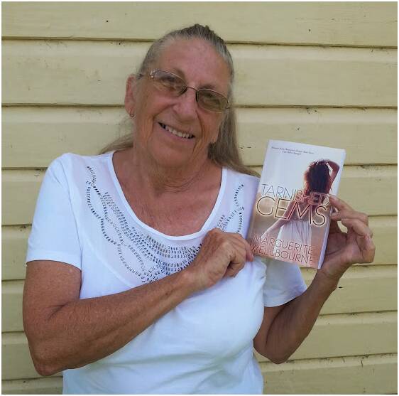 Author Maureen Larter, with a copy of her first adult fiction book.