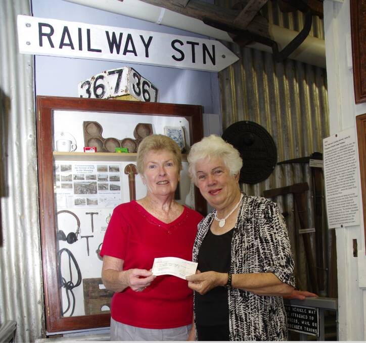 Wendy McKeough of the Centenary of Rail executive committee presents Barbara Waters of the Manning Valley Historical Society Museum with a cheque for $4000.