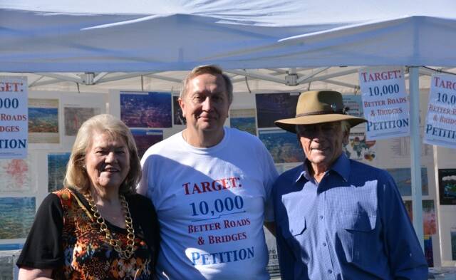 Eric and Mave Richardson stop to sign the target 10,000 petition at the Wingham Show, they are pictured with Clr Peter Epov.