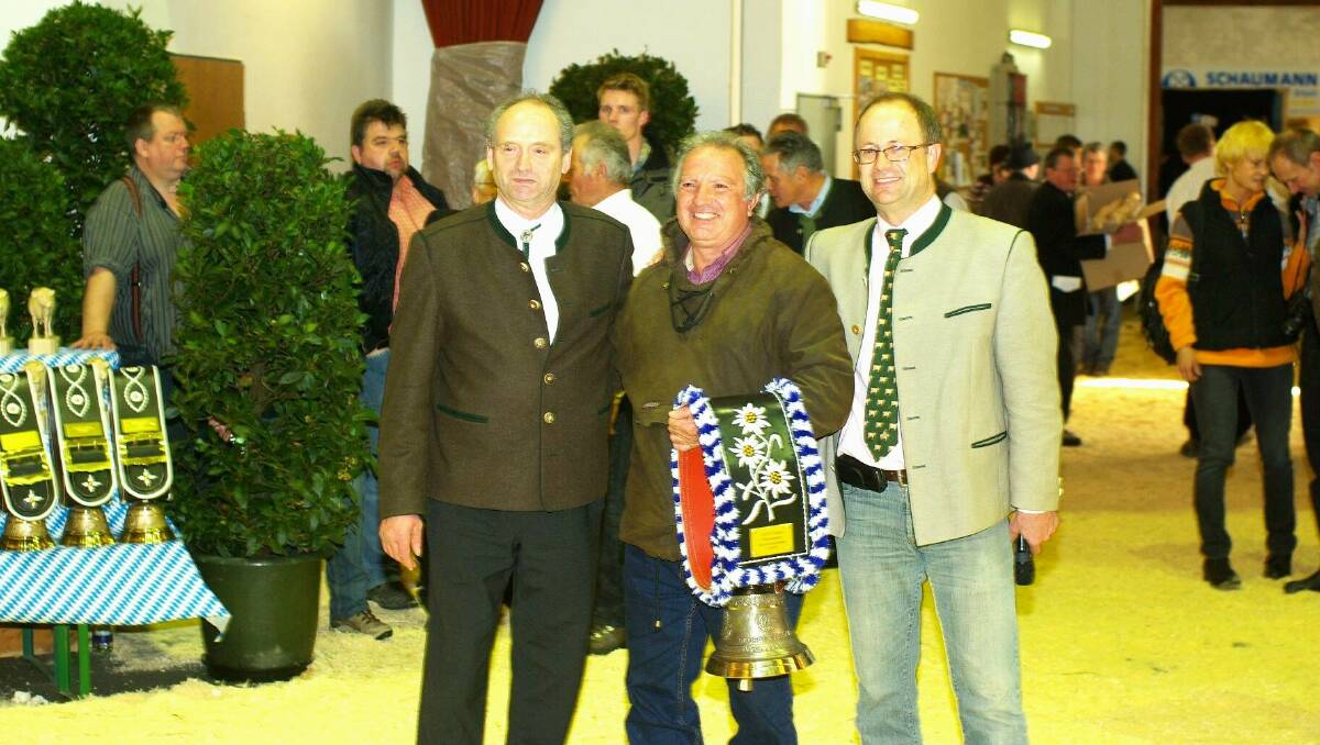George Cassar with the award he was presented with at Traunstein, Germany in 2009, flanked by Frank Sturzer, president of the Fleckvieh Breeders Association in Bavaria and Dr Thomas Grupp, from Bayen Genetik in Germany.