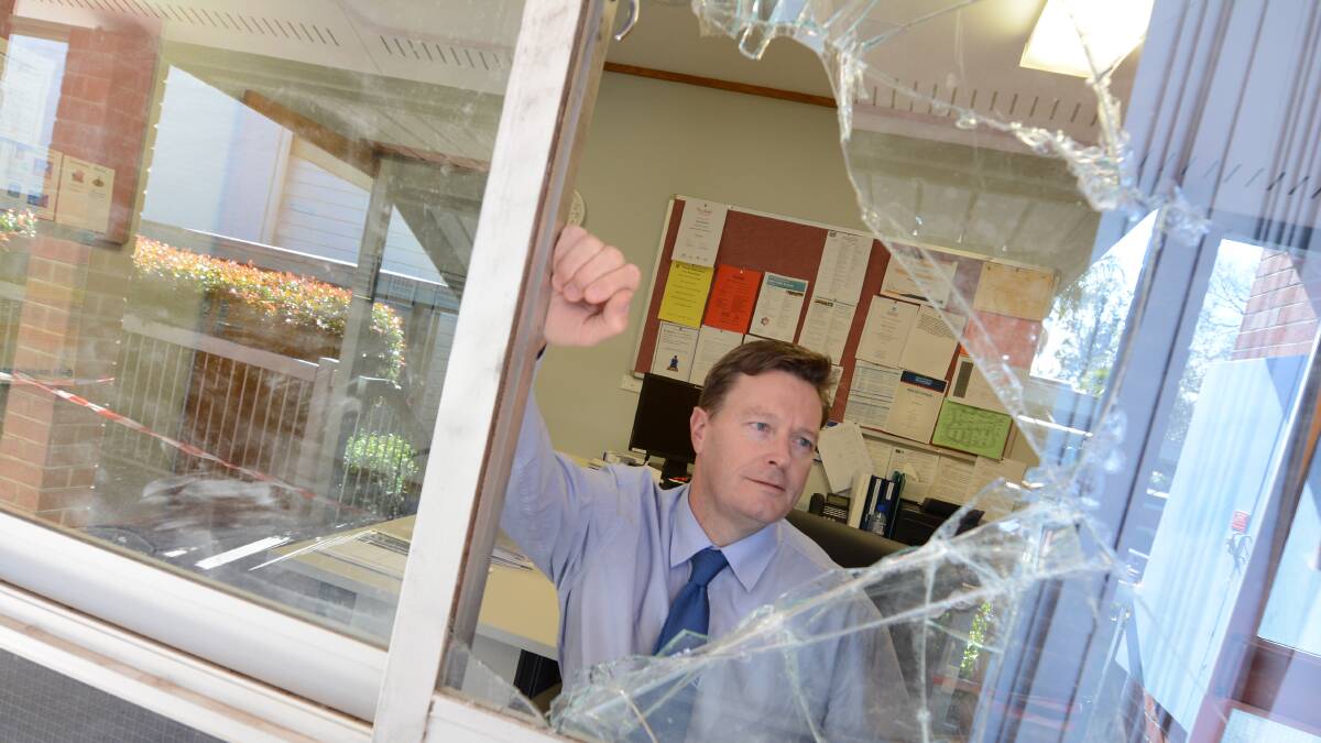 Tinonee Public School principal Nigel Sherrard looks through the smashed window in his office and says, "It's disappointing that they'd target a school."