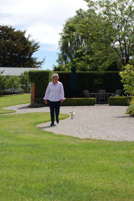 Susannah and Pepper, the trusty Jack Russell, head to the rose garden. Photo: MARINA WILLIAMS