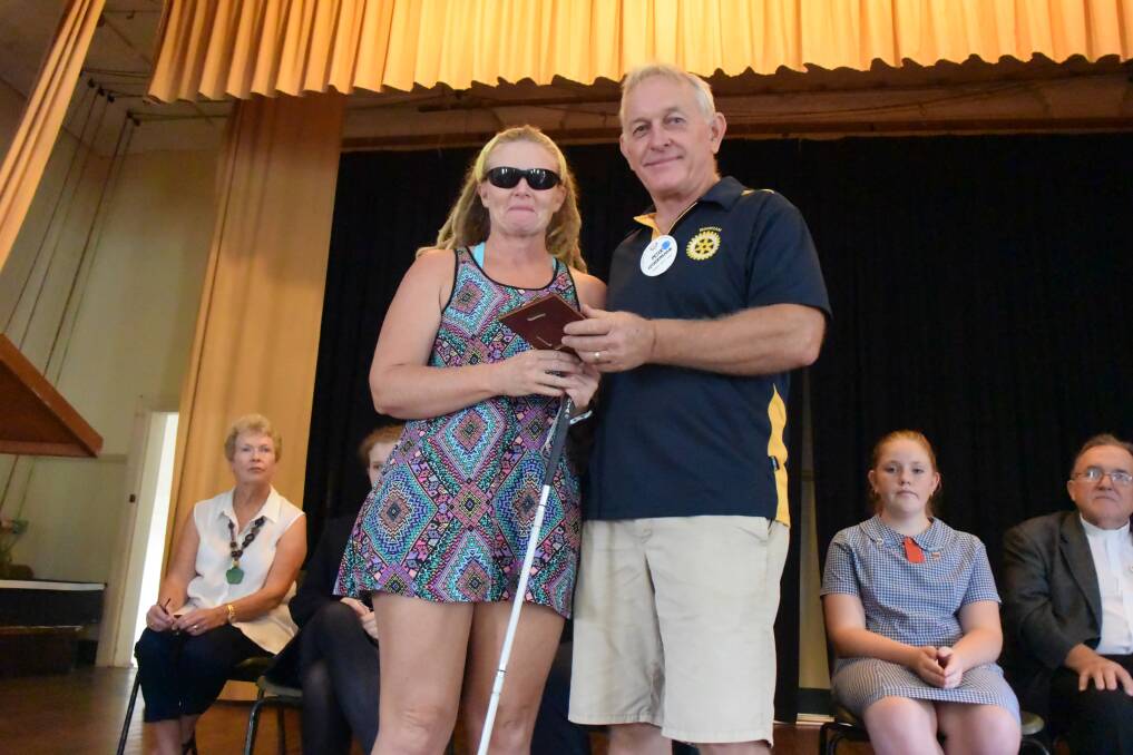 Sportsperson of the Year Vicki Farrow accepts her award from Wingham Rotary Club president Peter Fotheringham.