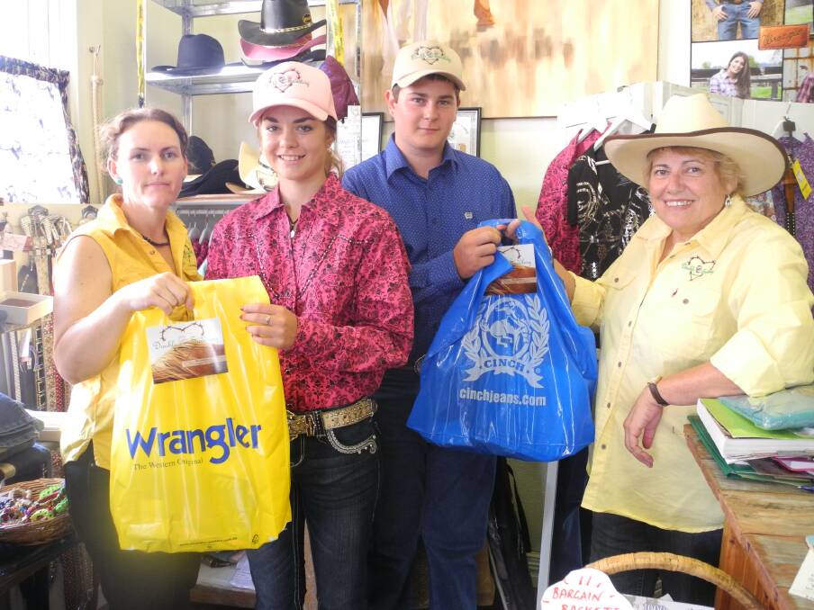 New sponsors of the Anderson family Candice Wilkinson and Carole Isaacs of Double C Saddlery Australia present Brooke and Aaron Anderson (centre) with products from their store.